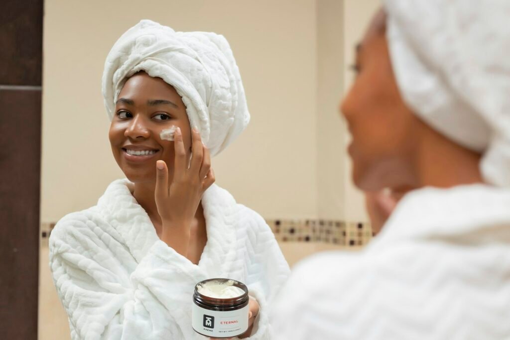 Two women in towels and robes enjoying a skincare moment